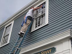 Washing window on high ladder